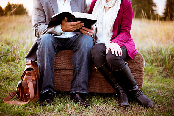 Man and woman sitting and reading together